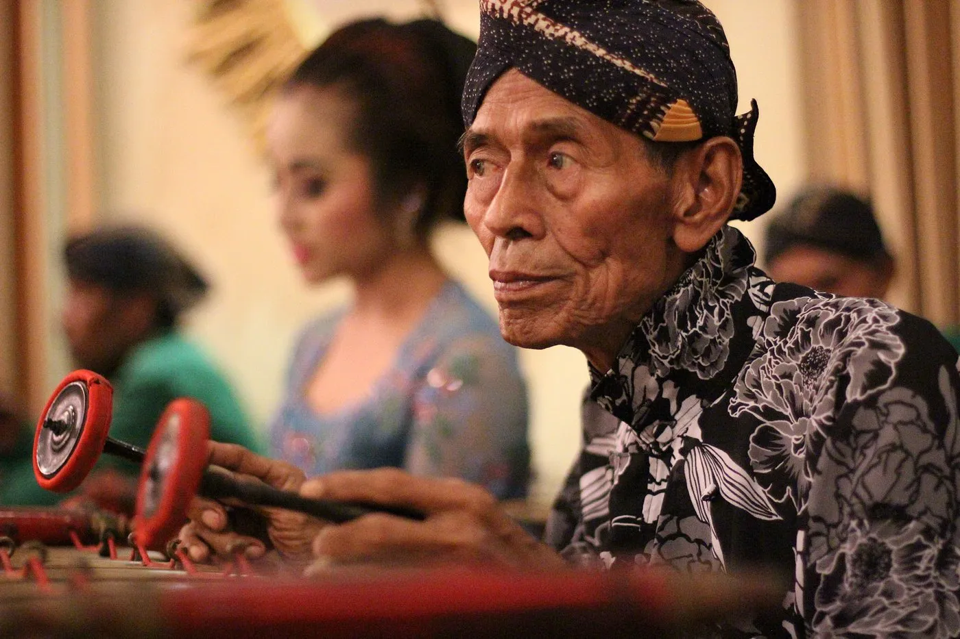 A musician playing gamelan during a live performance