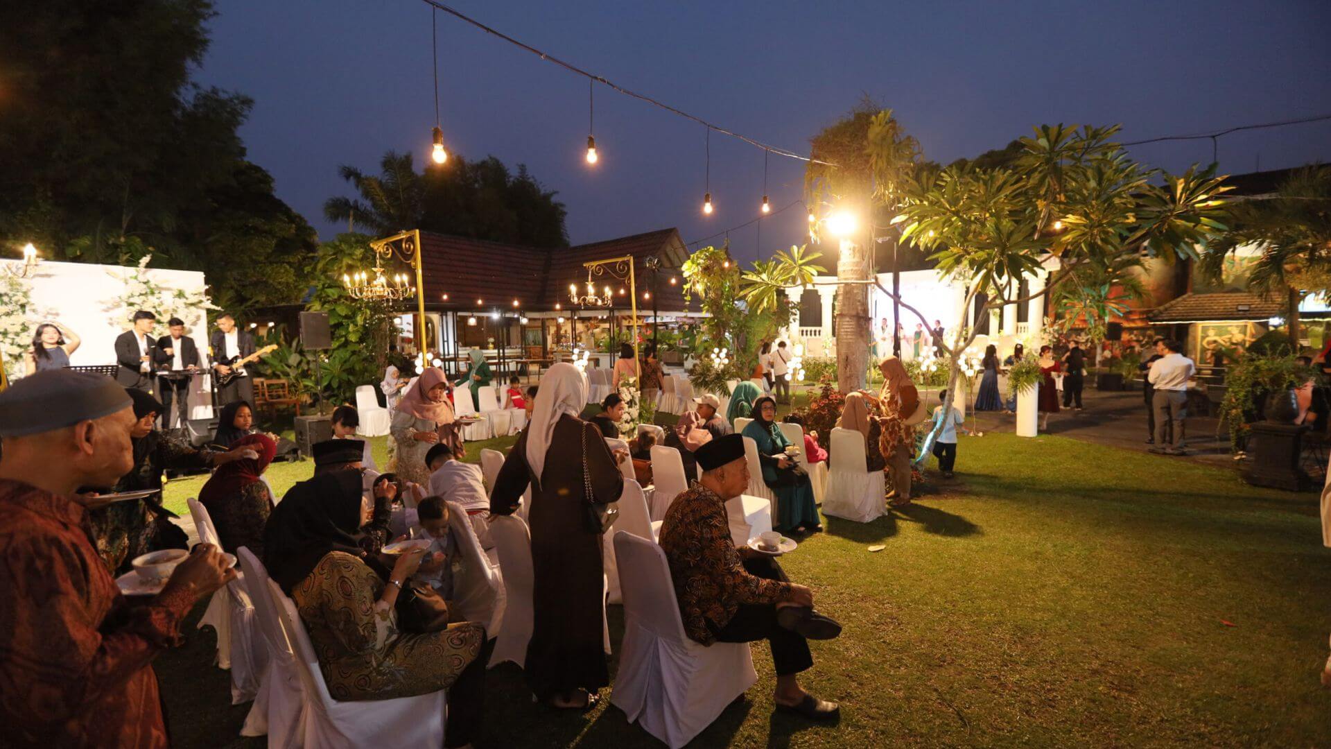 A social gathering beneath lights in Tasneem's garden