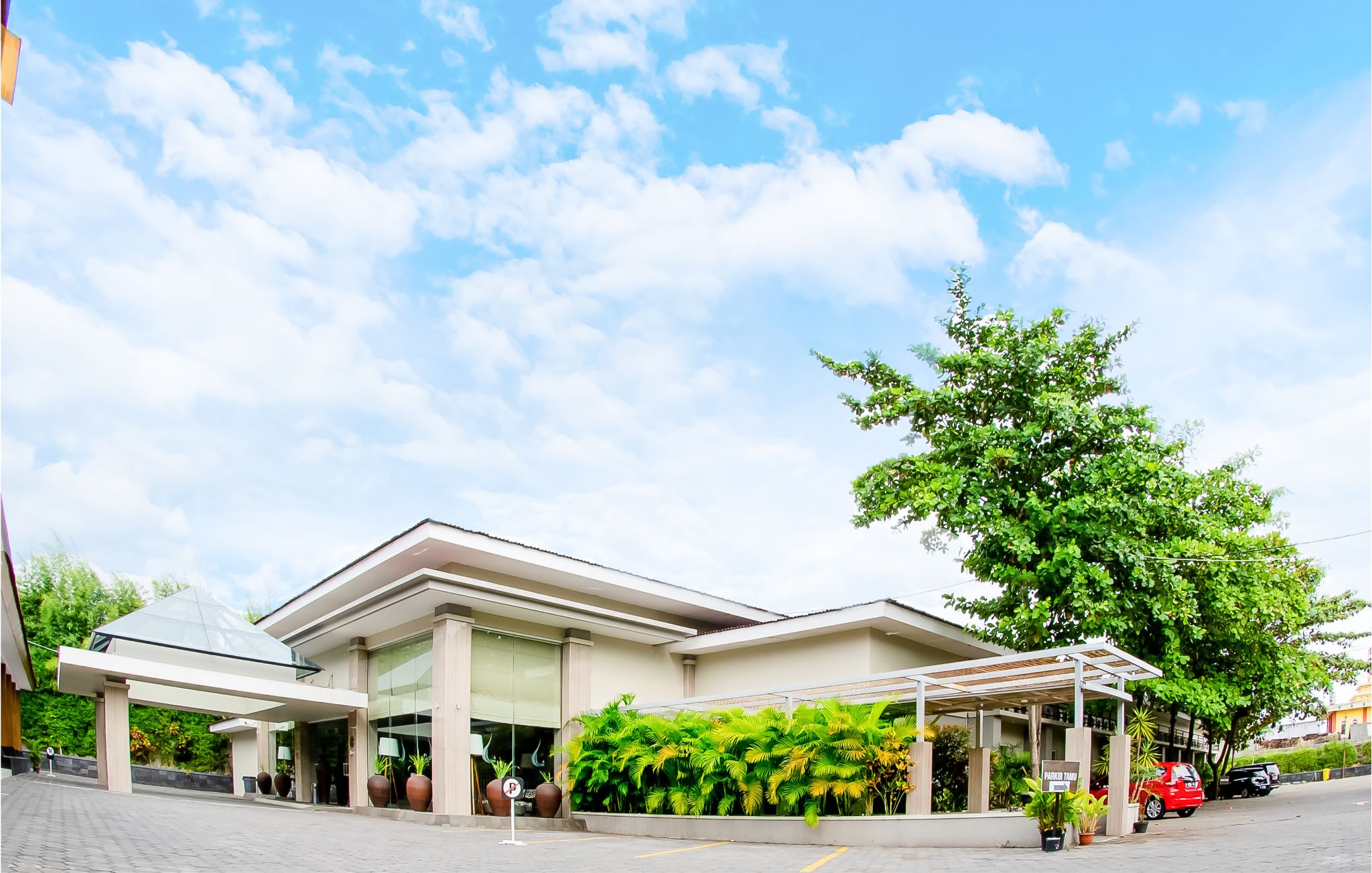 Exterior of Tasneem Hotel Malioboro beneath a broad Yogyakarta sky