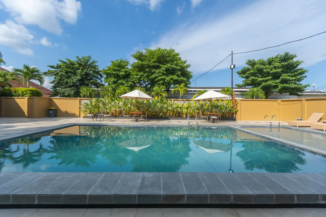 The blue swimming pool in the hotel gardens